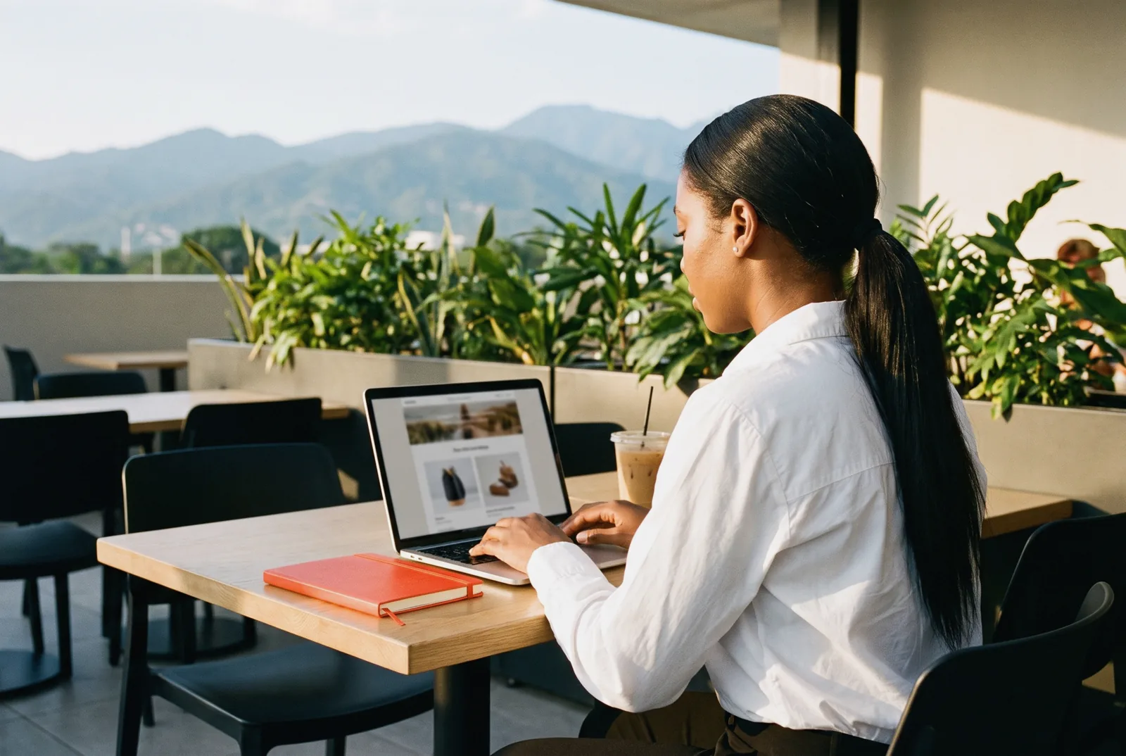Content strategist designing an email newsletter at a cafe