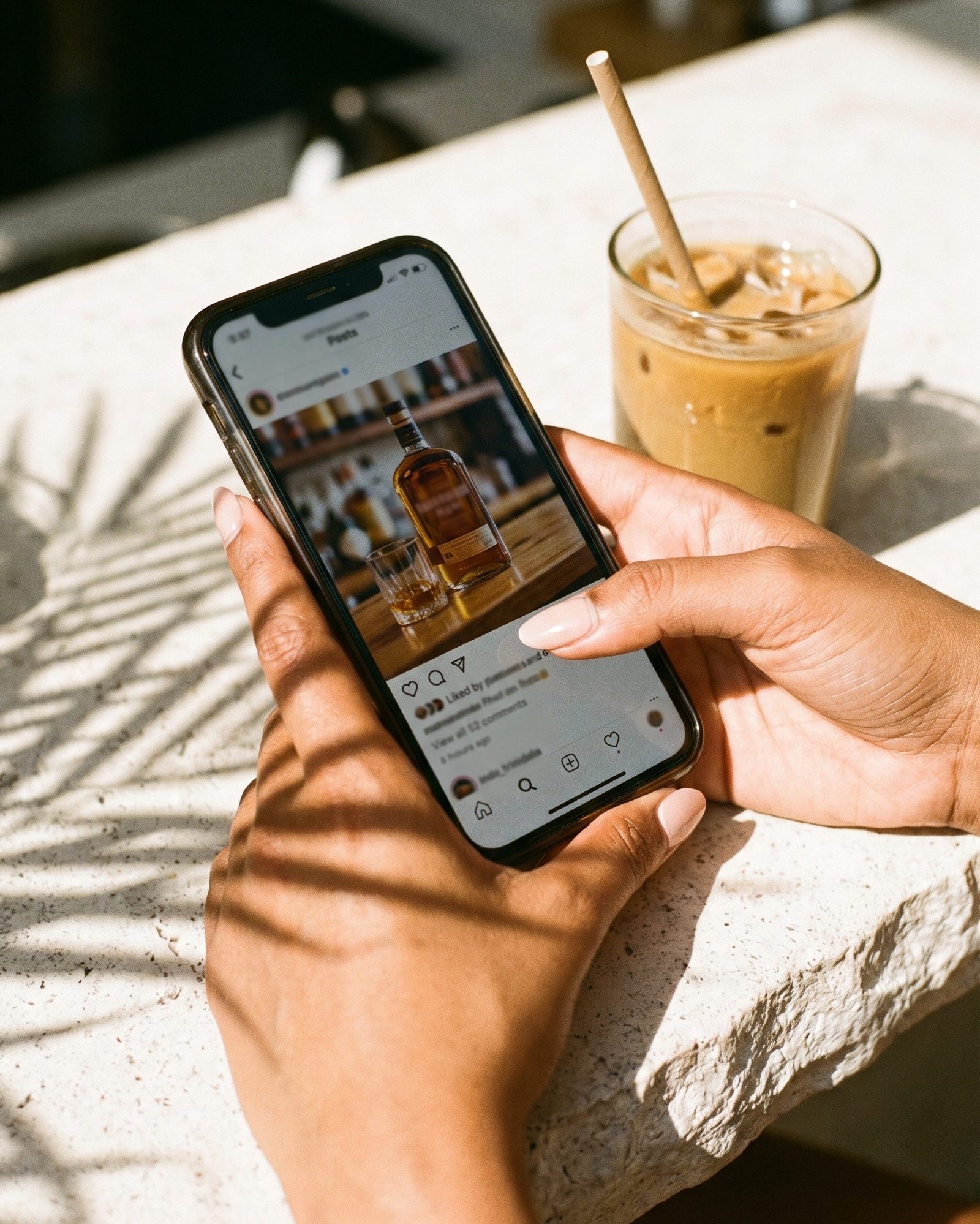 Hand holding a phone showing an Instagram post