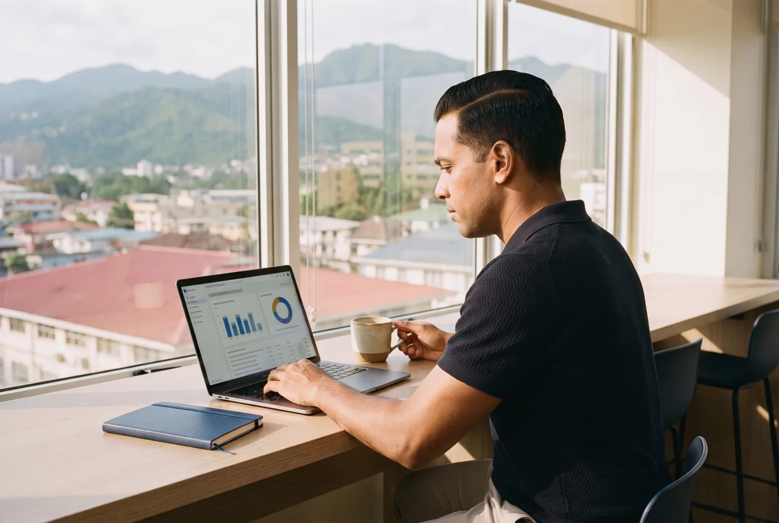Marketing manager reviewing website audience analytics on a laptop
