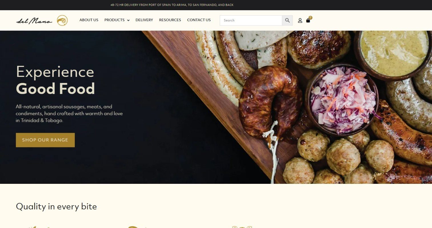 Del Mano homepage hero with grilled sausages and meatballs on a wooden board